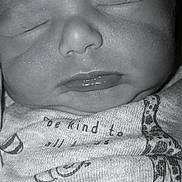 Jaxton is registered to the contest to win money with this photo: baby, close_up, sleeping, face, infant, black_and_white, chubby_cheeks, mouth, nose, skin_texture, clothing, fabric, printed_text, peaceful, portrait, newborn, young_child, soft_light, indoor, cute