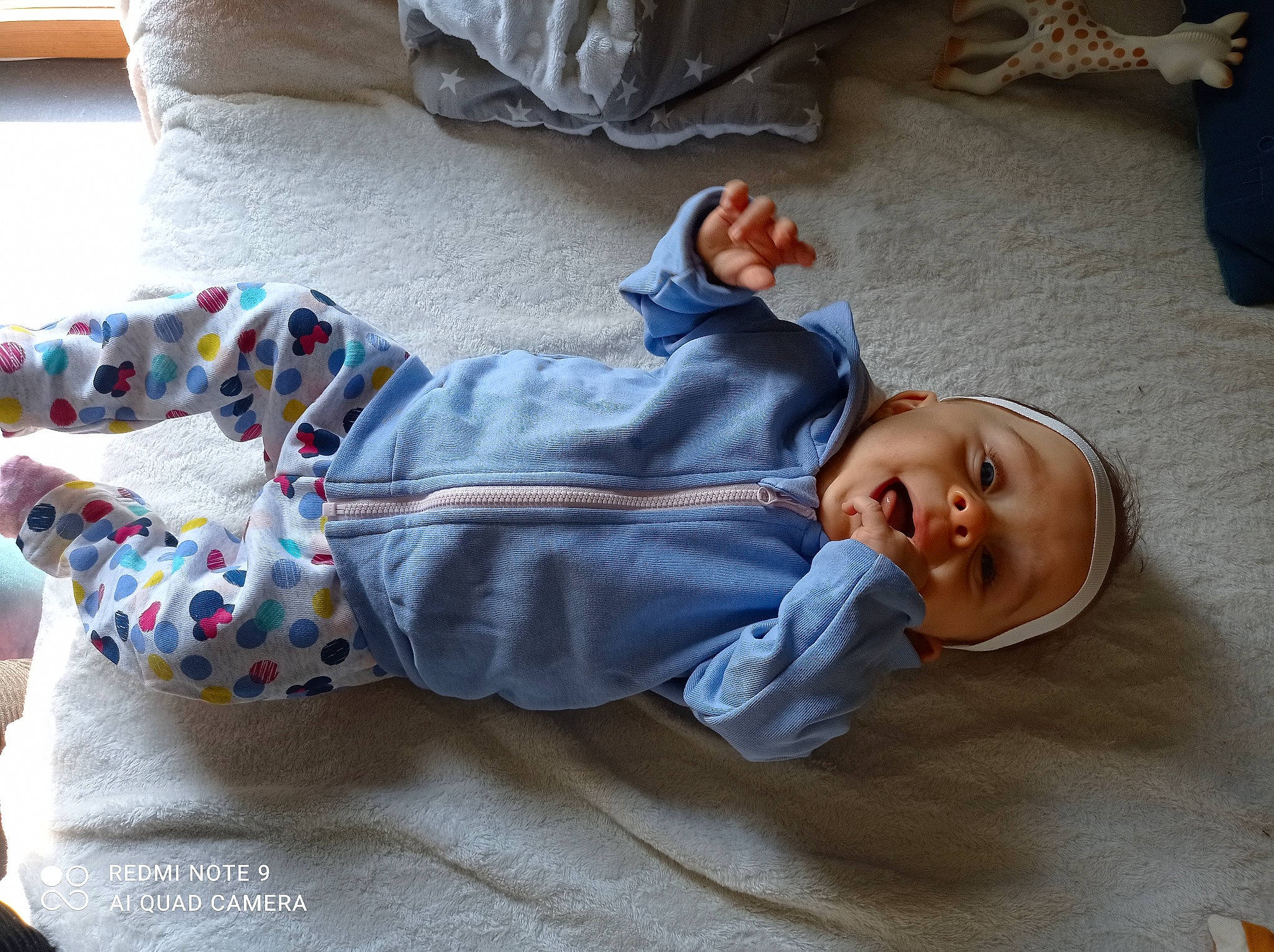 Eleana participe au concours pour gagner de l'argent avec cette photo : baby, baby_toddler_clothing, cheek, clothing, comfort, face, finger, floor, flooring, hand, head, human_body, joint, leg, nose, person, product, skin, sleeve, textile