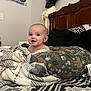 Jazlynn joined the competition — help win amazing prizes! baby, blanket, pillow, bed, headboard, hat, poster, wall, pattern, animal_print, geometric_pattern, smiling, child, indoor, cozy, comfort, person, happy, furniture, room