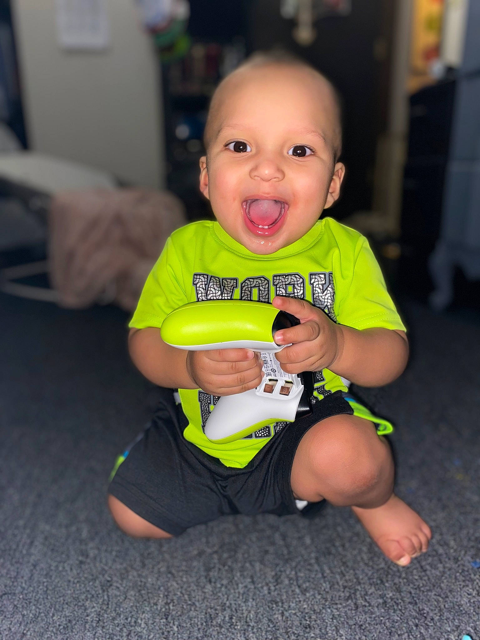 Leland joined the competition — help win amazing prizes! baby, baby_toddler_clothing, cheek, child, elbow, finger, floor, flooring, fun, happy, head, human_leg, iris, knee, person, sitting, skin, sleeve, smile, t_shirt