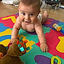 Tiago a rejoint le concours — aidez-le/la à gagner de superbes lots ! baby, child, crawling, toy, plush_toy, foam_mat, colorful, indoor, floor, diaper, smiling, happy, cute, person, playtime, infant, young_child, bright_colors, soft_toys, wooden_floor
