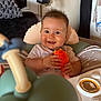 Tiago a rejoint le concours — aidez-le/la à gagner de superbes lots ! baby, child, smiling, toy, high_chair, indoor, happy, face, person, clothing, hand, furniture, head, expression, hair, seat, play, infant, closeup, home