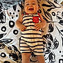 baby, child, smiling, striped_clothing, romper, blanket, pattern, pillow, happy, infant, indoor, cute, person, face, legs, hands, skin, lying_down, summer, text_patch