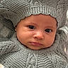 baby, infant, child, portrait, face, eyes, smiling, knitted_clothing, wool, hat, pom_pom, gray, cozy, blanket, indoor, close_up, sitting, fashion, cute, photography
