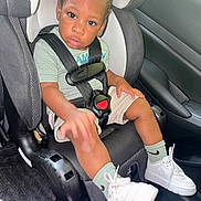 Kamdyn joined the competition — help win amazing prizes! toddler, child, car_seat, seatbelt, braided_hair, white_sneakers, green_socks, car_interior, sitting, safety, cute, curious, portrait, young_child, casual_clothing, footwear, car_door, seat, looking_at_camera, indoors