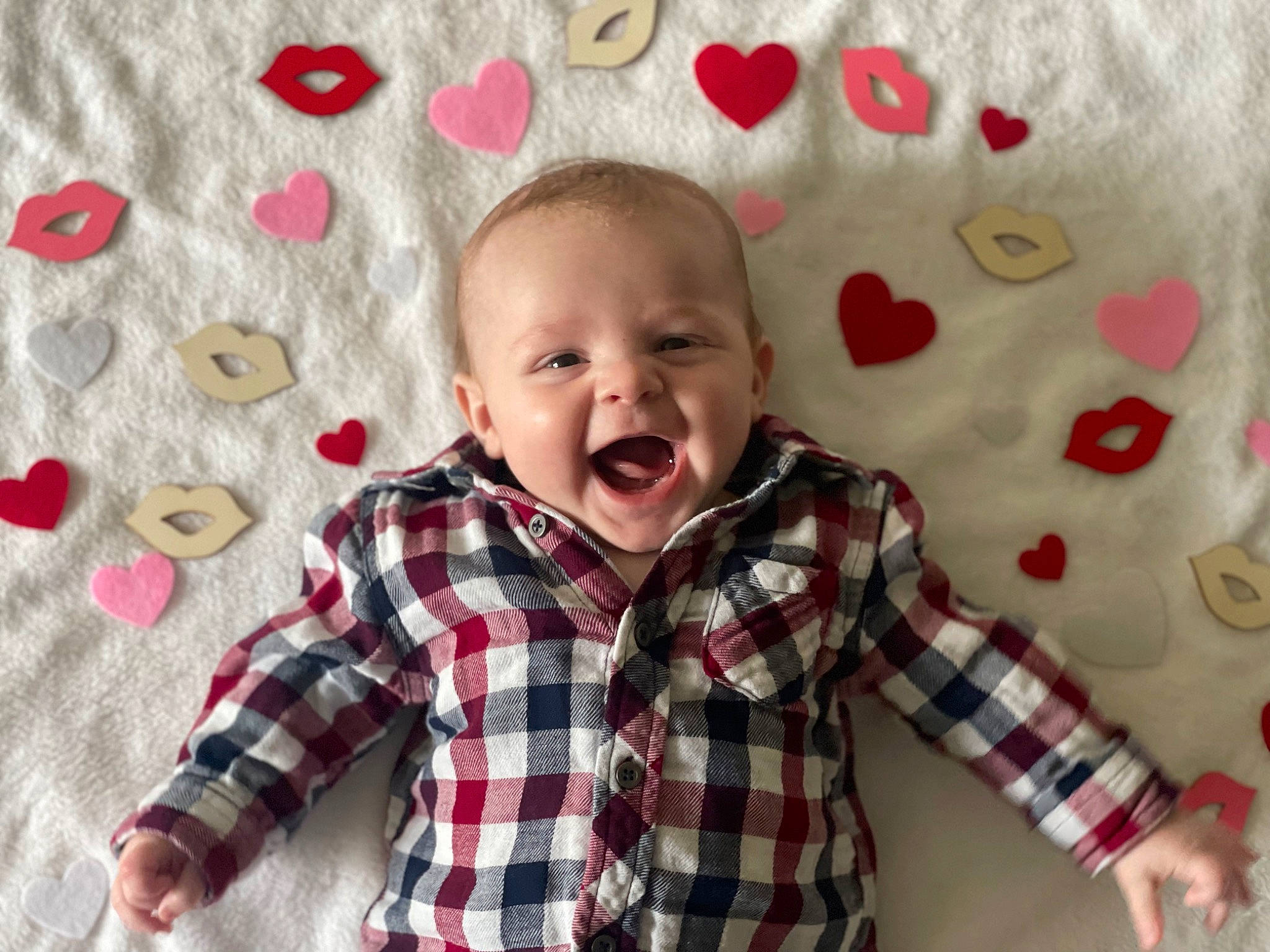 Robbie is registered to the contest to win money with this photo: baby, baby_toddler_clothing, child, collar, face, happy, head, linens, pattern, person, pink, plaid, product, red, skin, sleeve, smile, tartan, textile, toddler