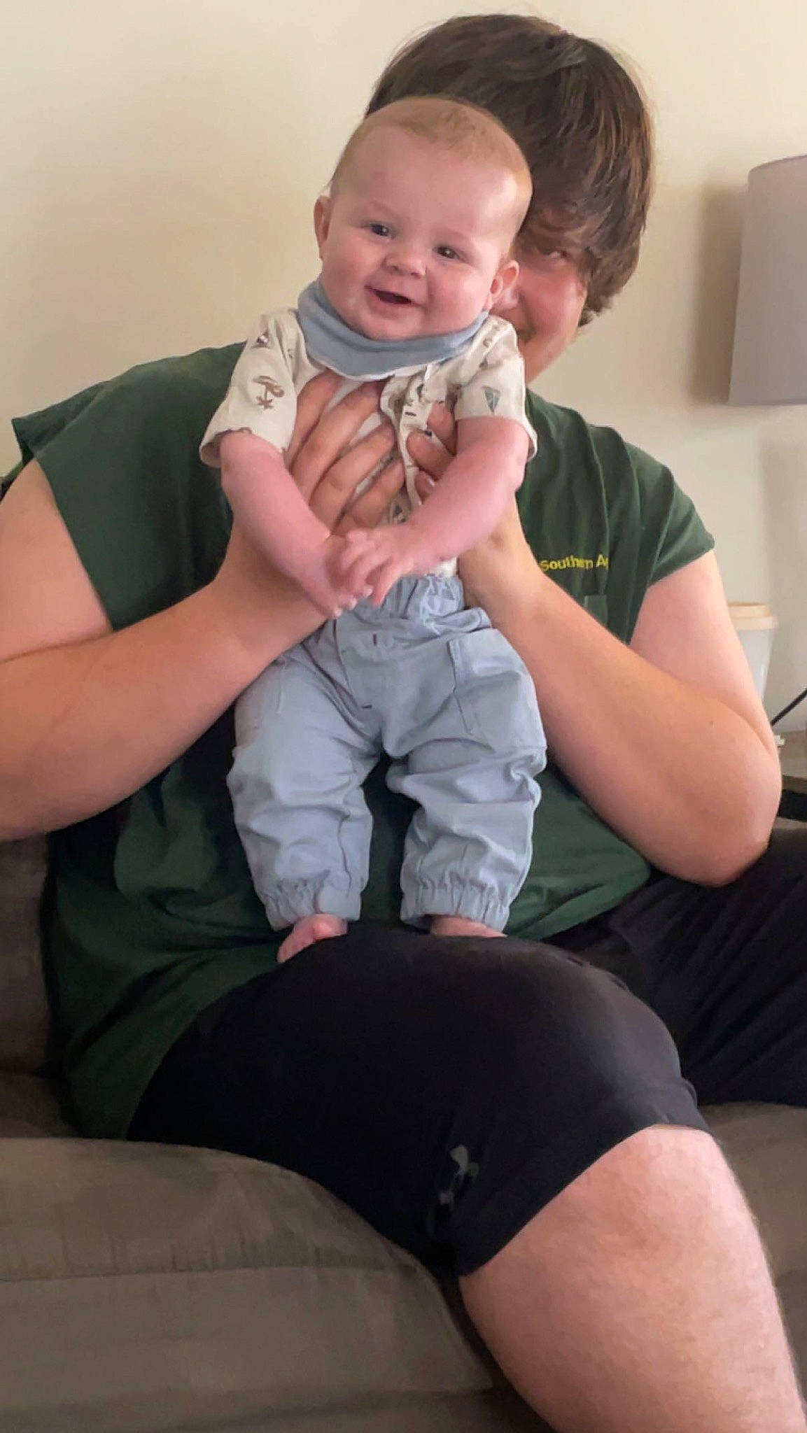 Robbie is registered to the contest to win money with this photo: baby_toddler_clothing, cheek, comfort, face, finger, gesture, happy, joint, lap, leg, mammal, mouth, muscle, person, pink, shoulder, skin, sleeve, standing, t_shirt
