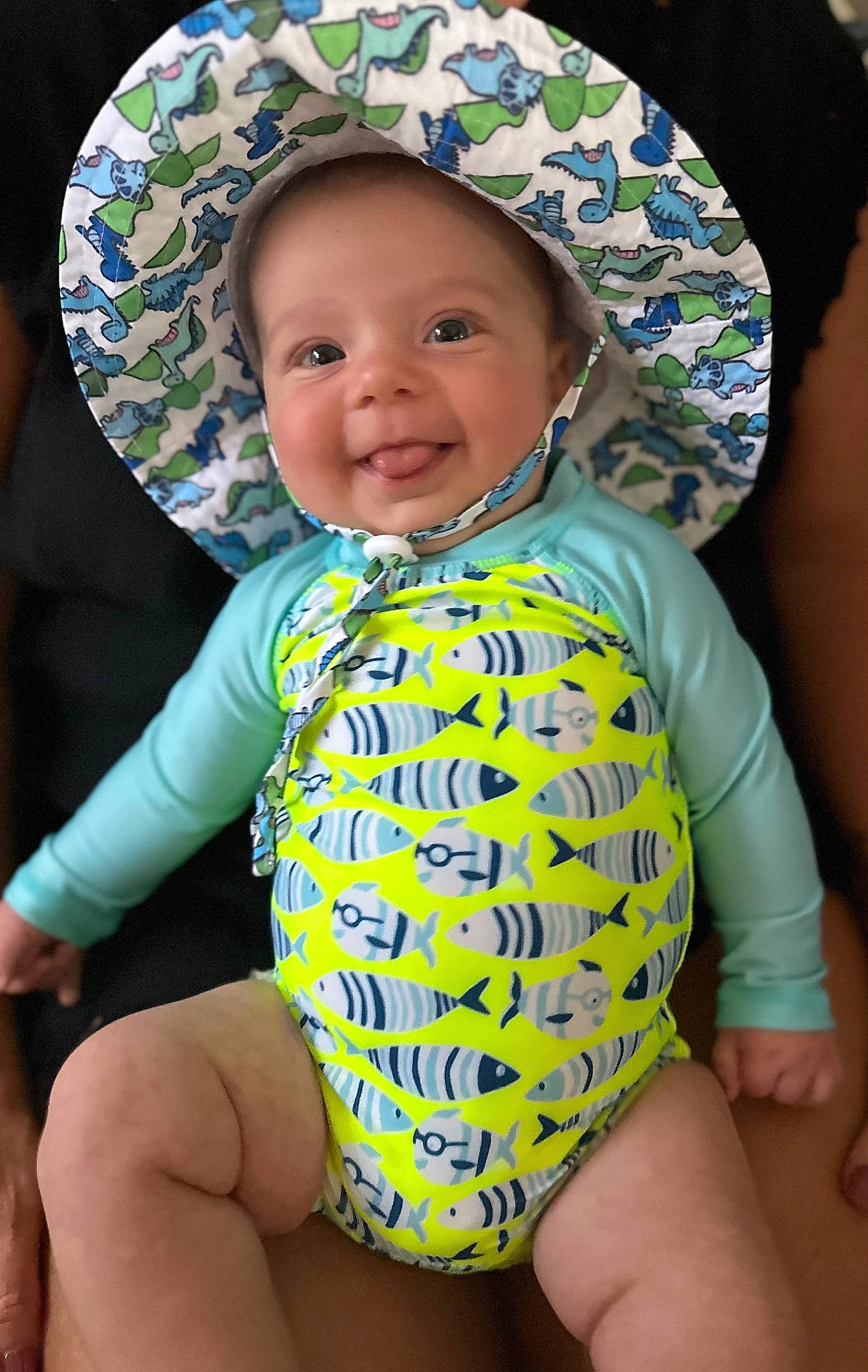 Maverick joined the competition — help win amazing prizes! baby, bonnet, cap, clothing, coat, costume, diaper, dress, face, happy, hat, head, jacket, person, photography, portrait, sitting, smile, sunhat, swimwear
