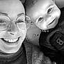 baby, woman, smiling, glasses, portrait, black_and_white, happy, face, closeup, person, toddler, apparel, eyewear, skin, head, child, indoor, expression, family, casual