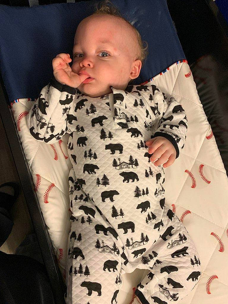 Brayden is registered to the contest to win money with this photo: baby, baby_products, baby_safety, baby_sleeping, baby_toddler_clothing, child, comfort, eye, finger, formal_wear, gesture, human_body, linens, military_camouflage, pattern, person, skin, sleeve, textile, thigh