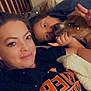 Mary Jane joined the competition — help win amazing prizes! woman, person, dog, bed, blanket, pillow, face, smile, indoor, casual, resting, cozy, snuggle, pet, hand, peace_sign, wall, shirt, relaxation, sparkles
