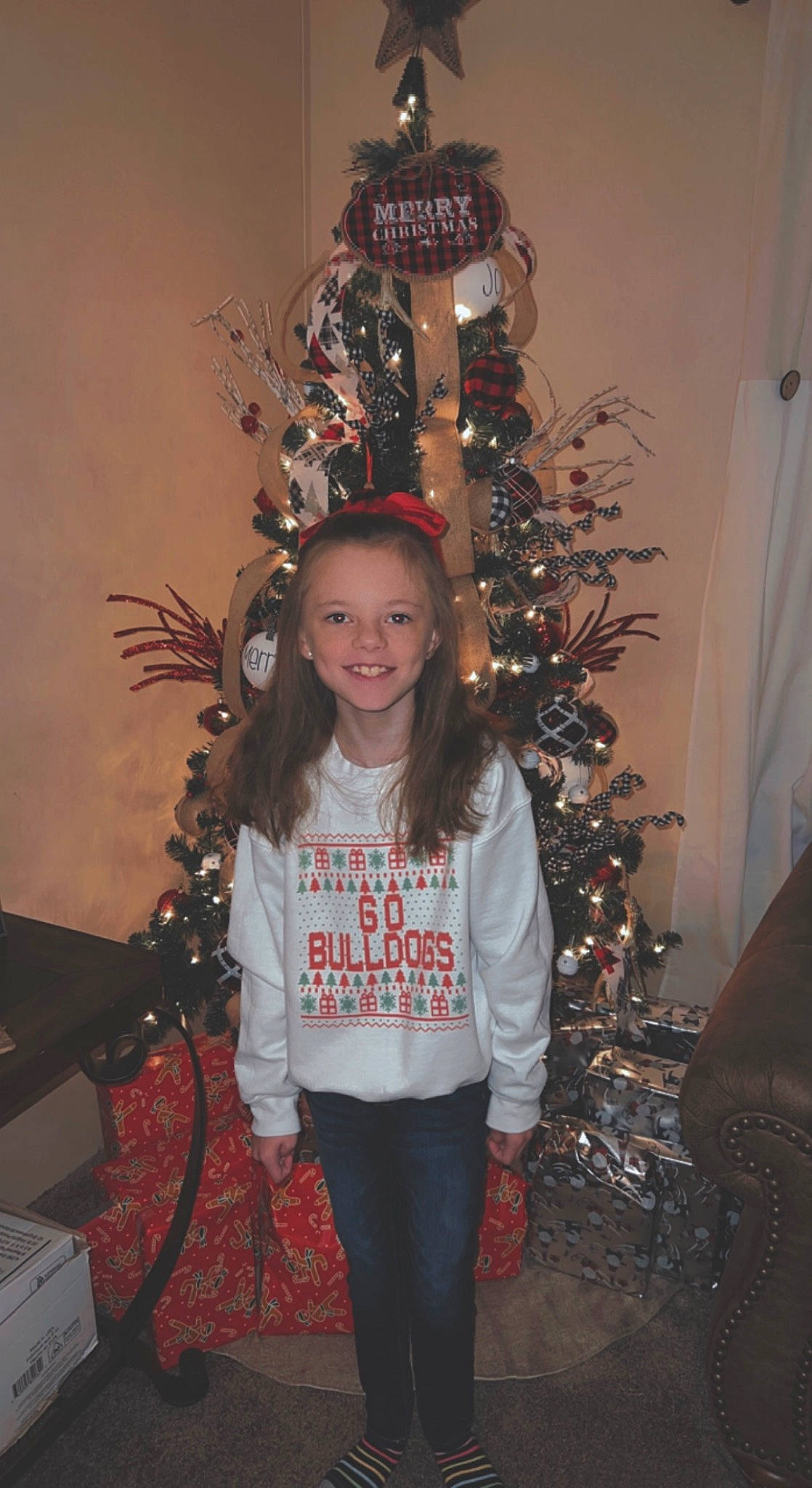 Brentleigh is registered to the contest to win money with this photo: branch, christmas, christmas_decoration, christmas_eve, christmas_ornament, christmas_tree, event, fun, hairstyle, happy, holiday, holiday_ornament, joy, ornament, person, plant, sleeve, smile, standing, twig