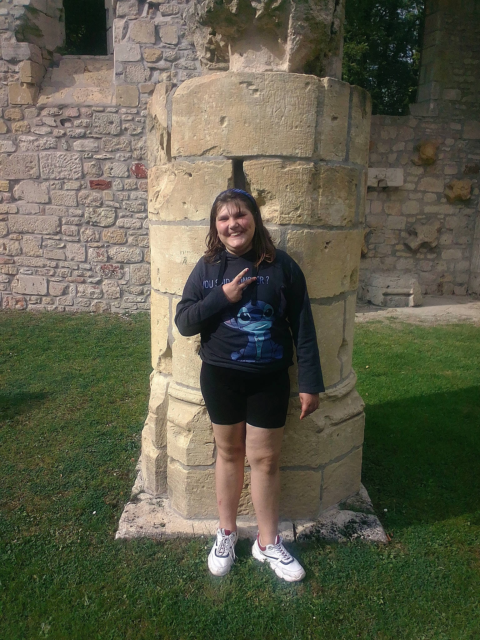 Kathy participe au concours pour gagner de l'argent avec cette photo : bag, fun, grass, handbag, happy, history, human_leg, joy, landscape, leisure, luggage_and_bags, monument, person, smile, standing, stone_wall, t_shirt, temple, thigh, tourism