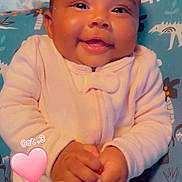Zamyah is registered to the contest to win money with this photo: baby, infant, child, smiling, happy, portrait, close_up, indoors, onesie, pink_clothing, blanket, bedding, animal_pattern, heart_sticker, text_overlay, date_text, lying_down, hands, cozy, photography