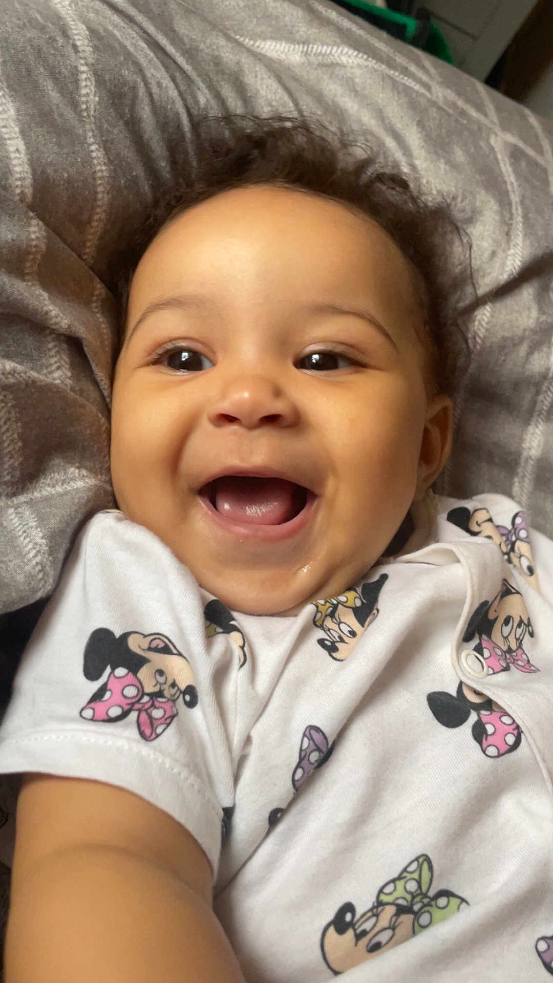 Delilah joined the competition — help win amazing prizes! baby, smiling, infant, cute, face, child, clothing, minnie_mouse, pattern, happy, lying_down, blanket, portrait, closeup, young_child, toddler, skin, hair, eyes, mouth