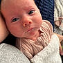 Isabelle is registered to the contest to win money with this photo: baby, newborn, infant, close_up, face, eyes, blanket, soft_texture, skin, clothing, pink, sleepy, peaceful, portrait, human, cute, child, resting, indoors, toddler