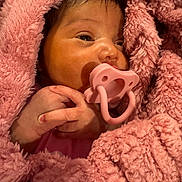 Tylyn is registered to the contest to win money with this photo: baby, pacifier, blanket, pink, infant, sleepy, hands, wrapped, cozy, soft_texture, newborn, cute, child, face, skin, portrait, warm, resting, closeup, comfort