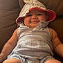 baby, child, infant, smiling, hood, clothing, couch, furniture, indoors, cute, chubby, happy, portrait, sitting, plush, soft, comfort, face, person, young
