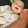 Kolsen joined the competition — help win amazing prizes! baby, smiling, onesie, animal_print, infant, face, person, arm, adult, clothing, happy, skin, closeup, lying_down, comfort, casual, textile, expression, cute, indoors