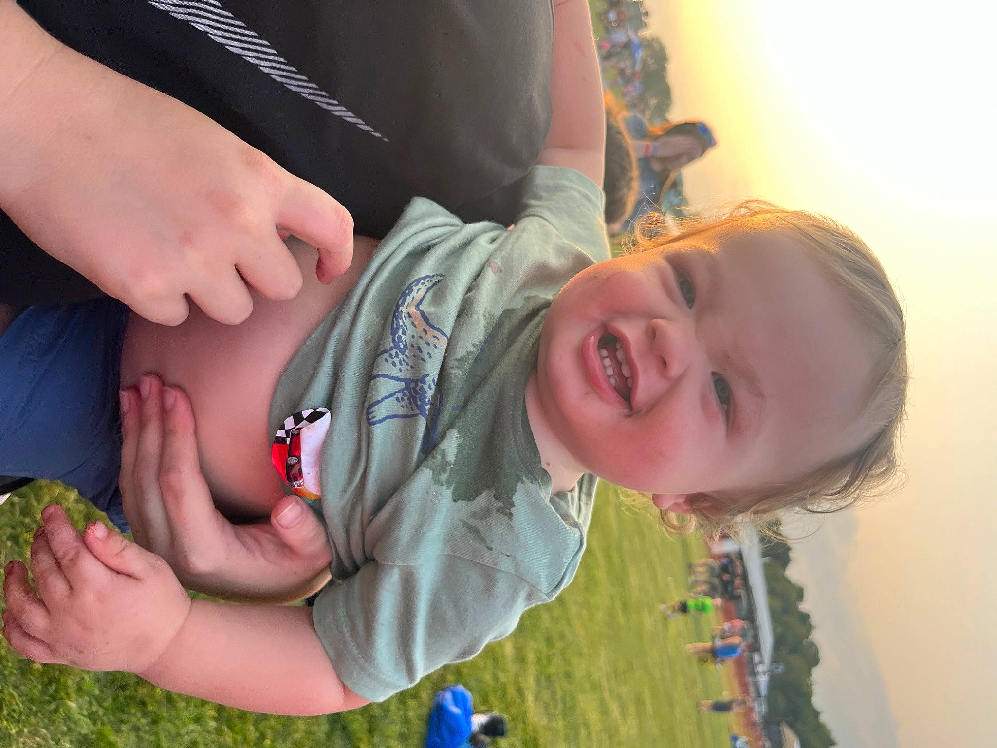 Ashtyn joined the competition — help win amazing prizes! baby, child, dress, finger, fun, gesture, grass, hand, happy, human_body, interaction, leisure, mouth, people_in_nature, person, plant, skin, smile, thumb, toddler