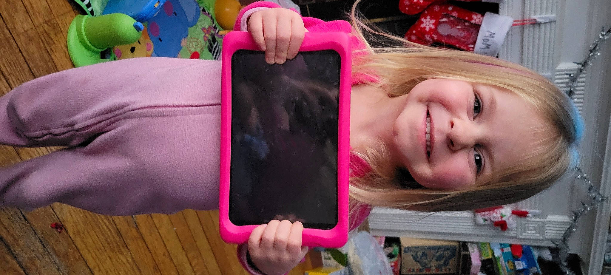 Rachel is registered to the contest to win money with this photo: child, communication_device, electronic_device, eyelash, finger, fun, gadget, gesture, hand, happy, joy, magenta, mobile_phone, person, photograph, pink, portable_communications_device, purple, smile, snapshot