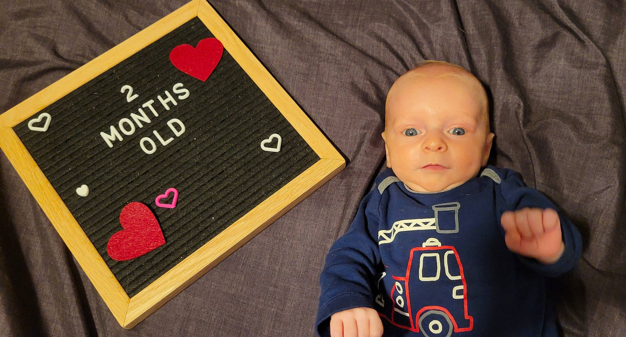 Rodney joined the competition — help win amazing prizes! baby, baby_toddler_clothing, brand, carmine, child, flooring, font, hoodie, jacket, logo, pattern, person, product, recreation, room, sitting, sleeve, smile, t_shirt, toddler