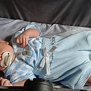 Connor joined the competition — help win amazing prizes! baby, sleeping, pacifier, blue_clothing, white_clothing, socks, blanket, animal_pattern, infant, peaceful, resting, cute, child, portrait, indoors, soft_lighting, closeup, toddler, young_child, cozy