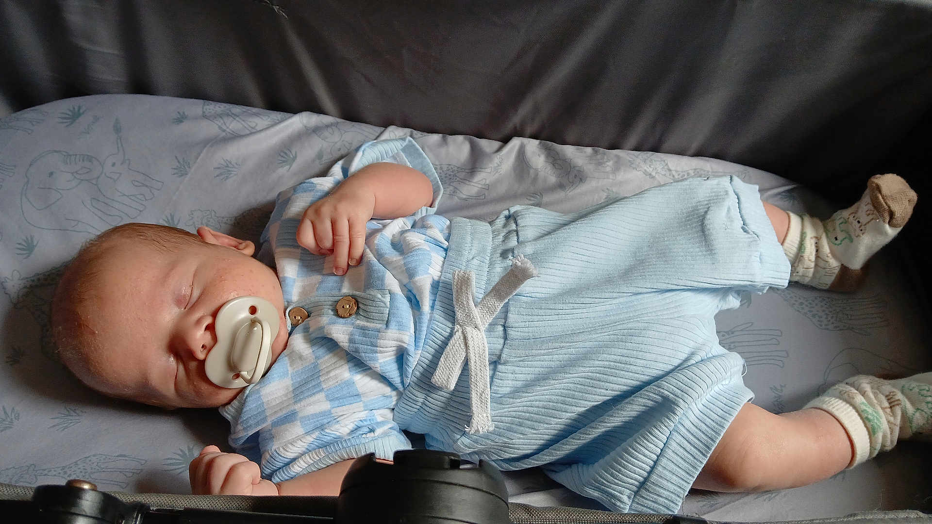 Connor joined the competition — help win amazing prizes! baby, sleeping, pacifier, blue_clothing, white_clothing, socks, blanket, animal_pattern, infant, peaceful, resting, cute, child, portrait, indoors, soft_lighting, closeup, toddler, young_child, cozy