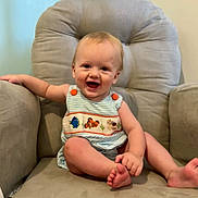 Miles is registered to the contest to win money with this photo: baby, child, smiling, armchair, furniture, indoor, cute, happy, person, clothing, striped, foot, hand, face, infant, seacreature, plush, comfort, portrait, sitting