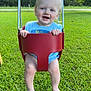 Miles is registered to the contest to win money with this photo: baby, child, swing, outdoor, grass, greenery, happy, smiling, blue_eyes, toddler, playground, sunny, nature, person, legs, barefoot, yellow_chain, red_swing, casual_clothing, daytime