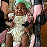 Milan joined the competition — help win amazing prizes! baby, bow, car_seat, child, close_up, colorful, cozy, face, happy, harness, headband, infant, onesie, outdoor_gear, photography, portrait, rainbow, seated, smiling, stroller