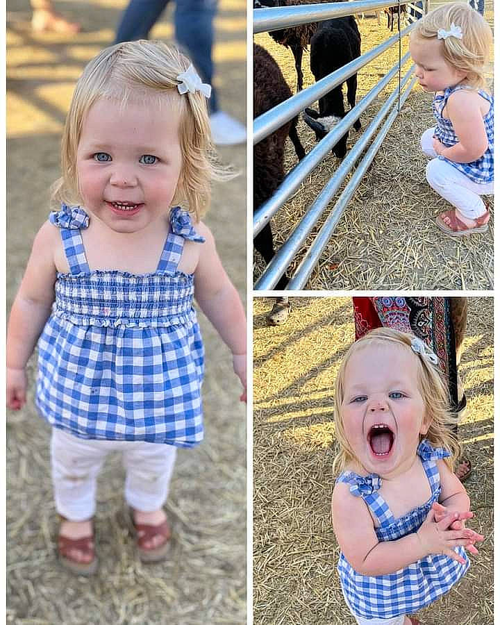 Georgia is registered to the contest to win money with this photo: baby_toddler_clothing, blue, clothing, facial_expression, fun, gesture, hairstyle, happy, joy, mammal, outerwear, people, person, photograph, plant, product, sleeve, smile, toddler, vertebrate