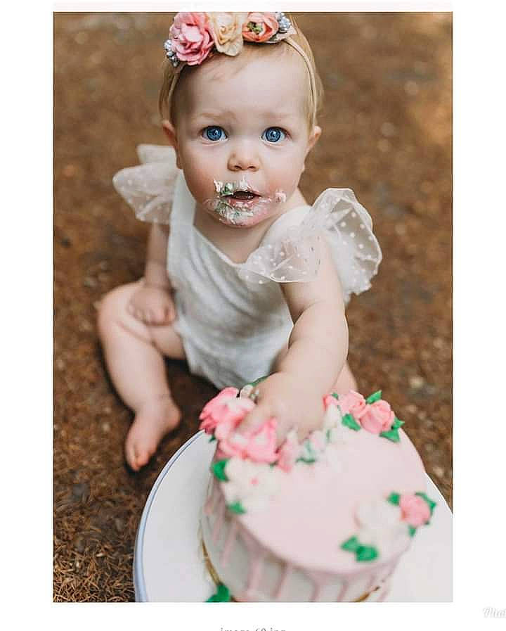 Georgia is registered to the contest to win money with this photo: baby, baby_toddler_clothing, baked_goods, birthday_cake, buttercream, cake, cake_decorating, cake_decorating_supply, child, dress, event, flash_photography, happy, headpiece, jewellery, person, petal, pink, sugar_cake, surprise