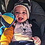 Benoît a rejoint le concours — aidez-le/la à gagner de superbes lots ! baby, car_seat, cheeks, closeup, colorful, cute, eyelashes, goggles, hands, happy, hat, infant, plush_toy, pompom, portrait, smiling, stroller, sweater, toy, winter_clothing