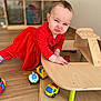 Lyana a rejoint le concours — aidez-le/la à gagner de superbes lots ! baby, blue_eyes, cheek, child, climbing, cute, ear, face, furniture, hand, hardwood_floor, indoor, playroom, playtime, polka_dot, red_dress, scrunched_expression, toddler, toy_car, wooden_toy