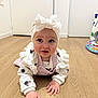 baby, bow, child, clothing, crawling, cute, expression, floor, flooring, hands, headband, indoor, infant, looking, person, playmat, room, sweater, toys, wooden_floor