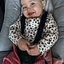 baby, baby_seat, child, clothing, cozy, cute, face, gray_cushion, hands, happy, indoor, infant, leopard_print, long_sleeve, person, pink_pants, portrait, seatbelt, smiling, straps