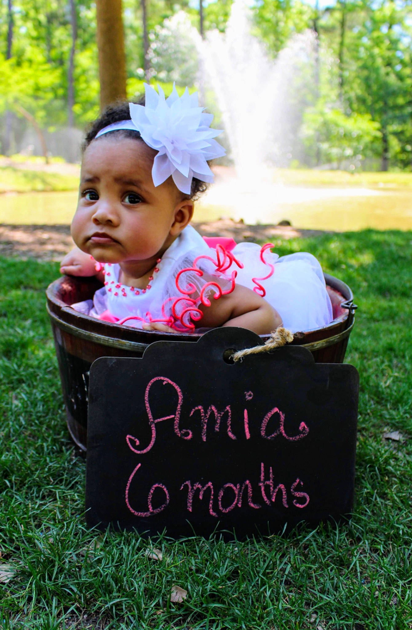 Amia is registered to the contest to win money with this photo: baby, baby_products, baby_toddler_clothing, basket, child, grass, headgear, person, photography, pink, product, toddler