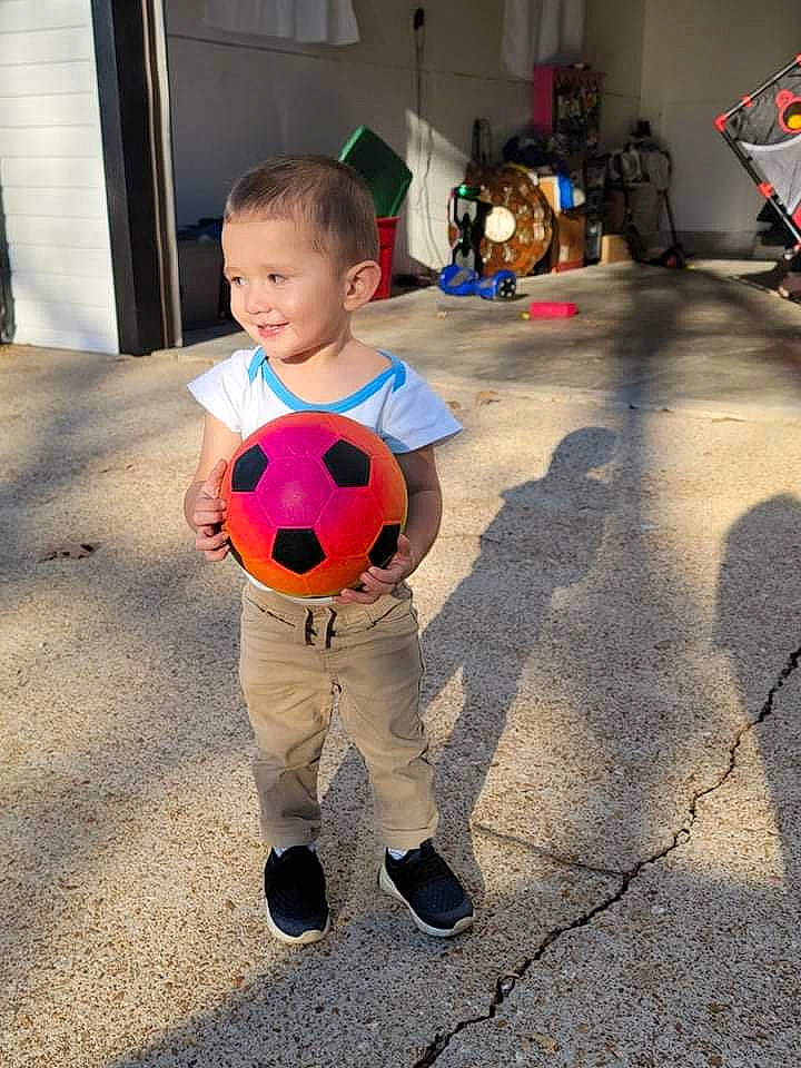 Neil is registered to the contest to win money with this photo: art, ball, carmine, child, design, flag, floor, flooring, football, fun, happy, head, joy, pattern, person, play, pumpkin, smile, soccer_ball, sports_toy