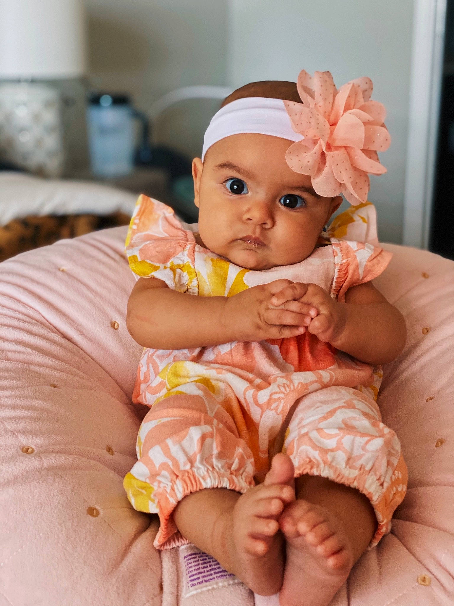 Sage joined the competition — help win amazing prizes! baby, baby_toddler_clothing, cheek, comfort, dress, eye, face, facial_expression, finger, hairstyle, happy, head, headwear, iris, mammal, orange, peach, person, pink, sitting