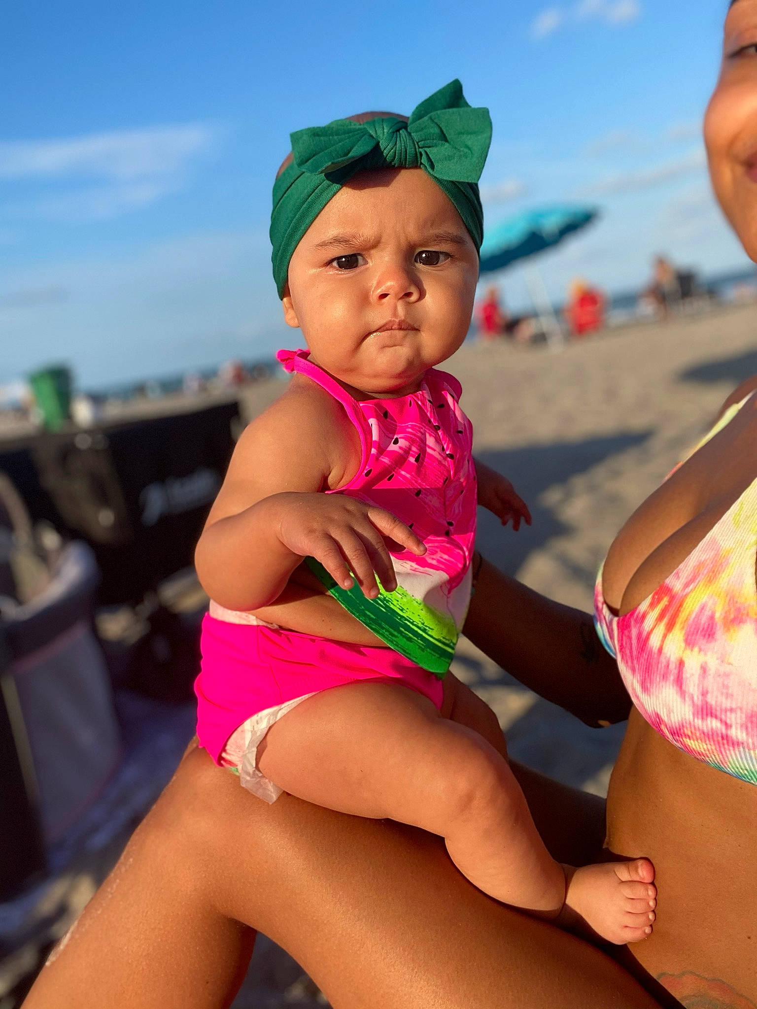 Sage is registered to the contest to win money with this photo: abdomen, child, cloud, facial_expression, fun, happy, hat, headwear, human, leg, leisure, people_on_beach, person, pink, skin, sky, summer, thigh, toddler, travel