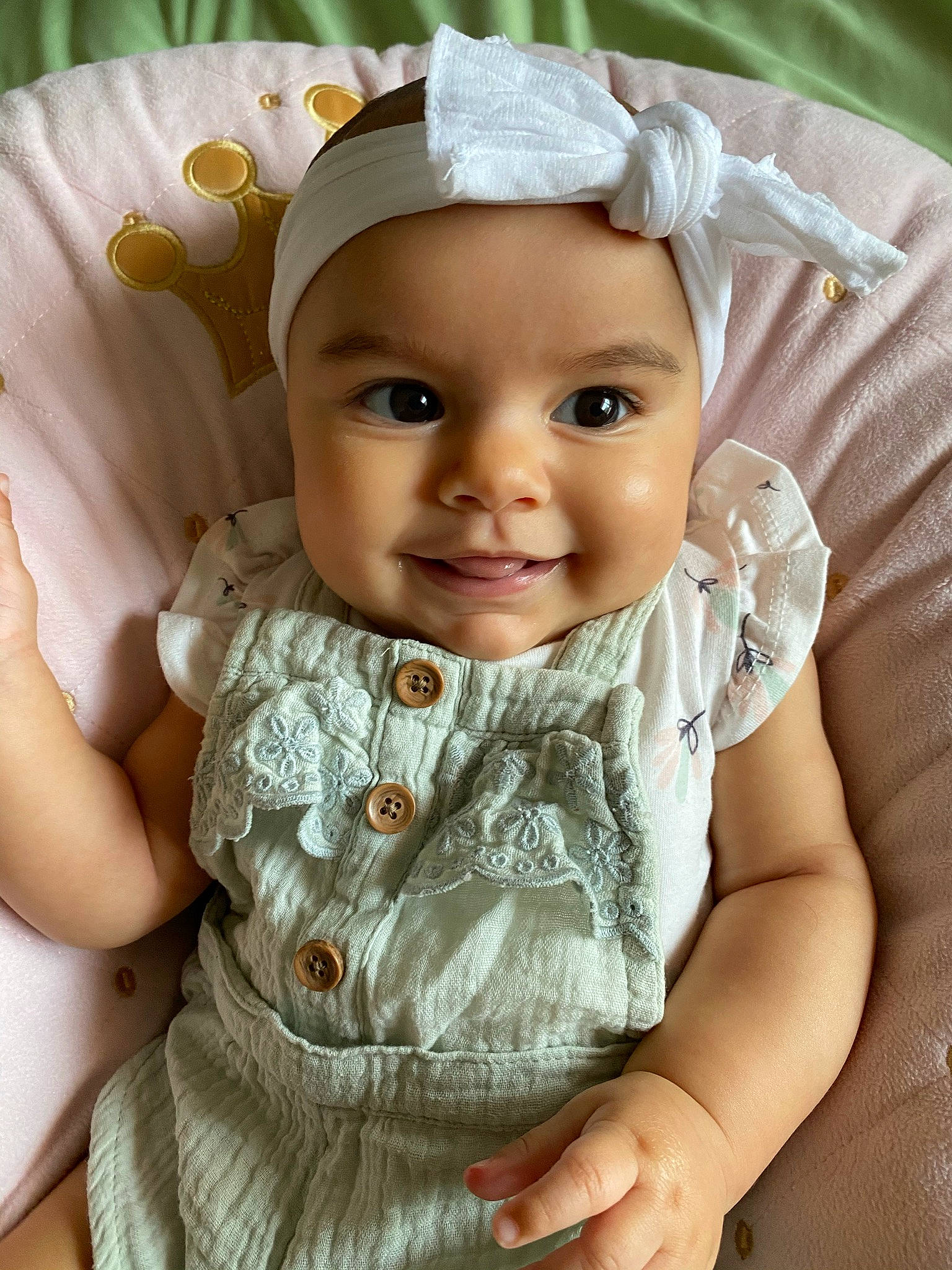 Sage is registered to the contest to win money with this photo: baby_toddler_clothing, cheek, eye, facial_expression, finger, flash_photography, gesture, hand, happy, head, headwear, iris, joy, lip, person, pink, product, skin, sleeve, smile