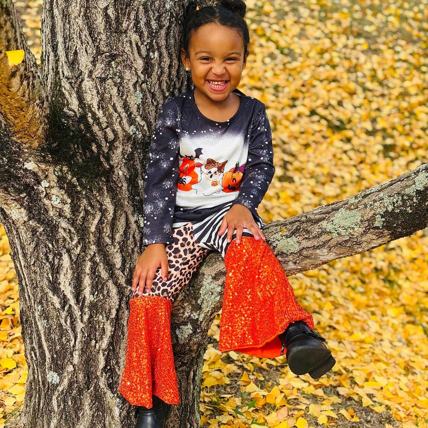 Kaylani is registered to the contest to win money with this photo: autumn, child, clothing, face, female, footwear, girl, happy, head, jeans, leaf, pants, person, photography, plant, portrait, shoe, sitting, smile, tree