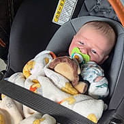 Levi joined the competition — help win amazing prizes! baby, blanket, car_seat, pacifier, plush_toy, infant, mittens, child, safety_belt, seatbelt, comfort, cute, soft, indoor, closeup, person, newborn, resting, adorable, protection
