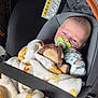 baby, blanket, car_seat, pacifier, plush_toy, infant, mittens, child, safety_belt, seatbelt, comfort, cute, soft, indoor, closeup, person, newborn, resting, adorable, protection