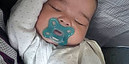 Analaiah is registered to the contest to win money with this photo: baby, sleeping, pacifier, onesie, arm, face, infant, resting, pillow, blanket, cute, peaceful, indoor, child, soft, cozy, head, closed_eyes, newborn, skin