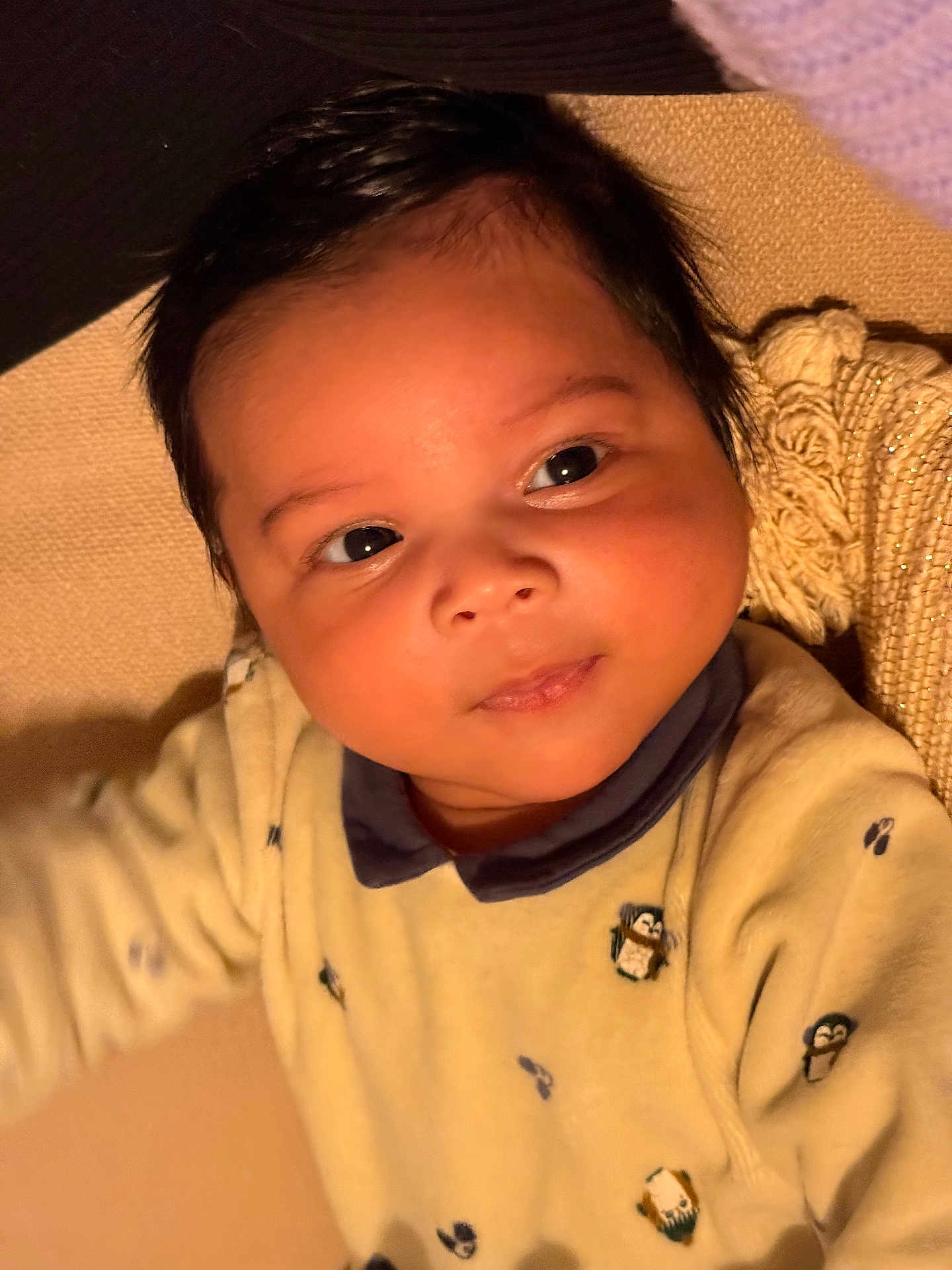Roméo participe au concours pour gagner de l'argent avec cette photo : baby, infant, face, eyes, hair, clothing, yellow_outfit, penguin_pattern, skin, closeup, portrait, child, cute, warm_lighting, expression, texture, fabric, indoors, soft, young