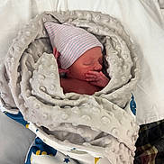 Jason joined the competition — help win amazing prizes! newborn, baby, blanket, hat, sleeping, wrapped, soft_texture, bed, infant, cute, peaceful, resting, cozy, child, portrait, indoors, human, small, delicate, comfort