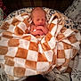 Jason is registered to the contest to win money with this photo: newborn, baby, blanket, checkered_pattern, cushion, sleeping, infant, cozy, soft_toys, animal_print, indoors, resting, cute, swaddled, peaceful, child, portrait, fabric, comfort, toddler