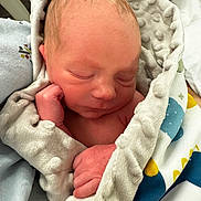 Jason is registered to the contest to win money with this photo: newborn, baby, sleeping, blanket, soft_texture, wrapped, peaceful, infant, hand, face, skin, cozy, cute, toddler, child, resting, indoors, comfort, portrait, closeup